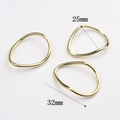 Detailed size comparison of 25mm and 32mm wavy irregular golden zinc alloy rings - Large / Gold