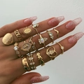 Detail of 13-piece bohemian gold ring set with heart and coin designs on hand - Gold Coin Totem Vintage Style (050105A1)