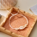 Handmade woven ocean bracelet featuring natural cowrie shell and starfish charms - Cream Shell Starfish (1)