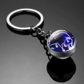 Luminous Taurus zodiac keychain featuring a double-sided glass ball with neon purple bull - Taurus