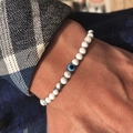 Men's 6mm marble stone beaded bracelet with a classic blue evil eye focal bead on a wrist - White Turquoise
