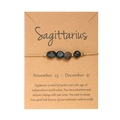 Dettaglio del bracciale zodiaco Sagittario fatto a mano con pietre naturali su carta kraft - Sagittario