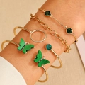 Detail of four-piece gold daisy and butterfly bracelet set worn on a female wrist - Gold (4259)