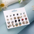 Detail view of 12 pairs of floral and heart stud earrings on a branded display card - Heart Moon Bow Snowflake Iridescent Set (ER23Y0816-9)