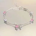 Elegant silver-tone bracelet featuring pink pear-cut stones and a jeweled bow charm - Pink Zirconia Bow Bracelet