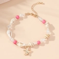 Close-up of ocean-style bracelet with natural seashell, starfish charm, and pink beads - Starfish Conch Pink Beaded Bracelet
