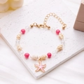 Detailed shot of sea shell and pink bead bracelet with starfish charm on marble - Starfish Conch Beaded Bracelet (Pink)