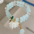 Double-layer light blue beaded bracelet with white floral charms and golden accents - Lake Blue Lily