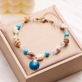 Summer beach anklet featuring blue shell pendant and colorful sea beads on a jewelry box - Blue Scallop (AK24Y0018-6)