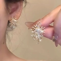 Gouden sterrenregen oorknopjes met fonkelende kristallen en kwastje voor dames - Stud oorbellen / Gouden Vuurwerk Stijl
