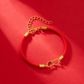 Close-up of red braided rope bracelet with interlocking gold hearts and lobster clasp - Red Rope With Gold Heart