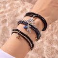 Detail of bohemian layered beaded bracelet featuring whale tail and seahorse pendants - Style 7