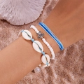Detailed shot of three bohemian ocean bracelets with shell, turtle charm and beads on beach - Style 19