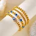 Set van vier gouden kralenarmbanden met Hamsa Hand en blauwe Evil Eye bedeltjes - Vier Laags Goud Boze Oog Stijl (BR24Y0532-2)