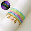 Detail of beaded bracelet set with ocean pendants and glowing fluorescent effect - Style 31