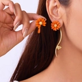 Asymmetrische oranje madeliefje oorbellen met een goudkleurige gebogen hanger - Lange Hangoorbellen Oranje