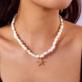 Bohemian seashell necklace with a textured golden starfish pendant on model - Gold Starfish Style (NC25Y0121-1)