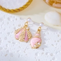 Macro detail of asymmetric ocean shell earrings with pink enamel and white micro pearls - White