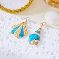 Detail of asymmetric shell earrings with blue enamel, pearls and a golden metal finish - Blue
