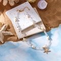 Boho-Strandhalskette mit weißen Kristallsteinen, Muscheln und goldenem Seestern - Halskette-Klar