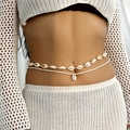 Detail of bohemian layered waist chain with natural sea shells and white seed beads on model - Shell Style