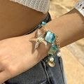 Golden starfish and blue bead layered bracelet with pearl accents on a sunny beach - Blue Square Bead Starfish Pendant Bracelet Style (NC25Y0356-Bracelet-Blue)
