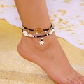 Three-piece bohemian starfish and shell beaded anklet set worn on a sandy beach - Three-Piece Set / Black White Gold Ocean Pearl Style (AK25Y0049-2)