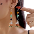 Close-up of Halloween pumpkin and ghost earrings with Wicked pendant on model - Pumpkin Ghost Beaded Drop Earrings