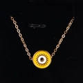 Detail of gold evil eye pendant with yellow enamel finish on black velvet background - Yellow