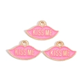 Close-up of three pink enamel lip pendants with gold Kiss Me lettering for jewelry DIY - Pink KISS ME Lip Style (px1244-2)