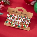 Detailansicht der Weihnachtsarmbänder mit Merry- und Joy-Buchstaben auf festlicher Karte - Rot Grün Gold Mit JOY Stil (#8)