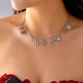 Close-up of a silver snowflake necklace with rhinestone pendants worn by a model - Silver Snowflake Pendant Necklace (Style 4)