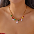Golden Christmas necklace with Santa, deer and colorful bell charms worn by a model - Necklace Style 2