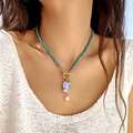 Ocean ceramic fish pendant necklace with blue beads and starfish on a model - Blue OT Clasp Style (NC25Y0362)