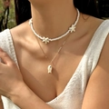 Detail of layered ocean necklace featuring white starfishes and ceramic fish pendant - White Double Layer Style (NC25Y0391)
