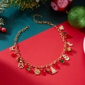 Macro detail of Christmas necklace with gold Santa, reindeer, and festive charms - Christmas Tree Snowman Snowflake Style / Gold