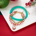 Close-up of Christmas bracelet set with Santa charm on a festive decorative plate - Cyan Santa Claus Style