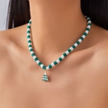 Detailed view of Christmas tree pendant on green and white heishi bead necklace - Green White Soft Clay Star Tree Style
