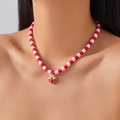Close-up of a festive Christmas necklace with red and white Heishi beads and gift box charm - Red White Soft Clay Gift Box Style
