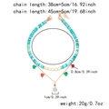 Detailed view of Christmas layered necklace with Merry beads, bells and tree pendants - Blue