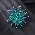 Detailed close-up of a sunflower brooch featuring deep teal crystals on a silver setting - Layered Floral Style (7938 Blue) / 7938 Blue