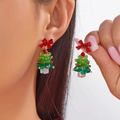 Christmas tree drop earrings with red bows and green crystal beads worn by a model - 红色立体蝴蝶结立体水晶珠圣诞树款