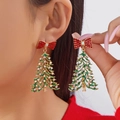 Detailed close-up of Christmas tree earrings with red bow and sparkling rhinestones - 红色蝴蝶结密镶绿银钻圣诞树款