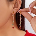 Detail of long Christmas earrings with HAPPY letters and red star pendant on a model - HAPPY圣诞元素字母垂直排列长坠款