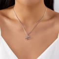 Silver snowflake pendant necklace with cubic zirconia on model for festive look - Snowflake Pendant Necklace (#NC25Y0828) / Silver