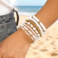Bohemian multilayered beaded stretch bracelet set featuring white resin and gold beads - Style 5 / 7-Pack Set