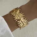 Golden cuff bracelet featuring vintage bohemian sun face relief and sunburst design - Wide Version Sun Face (BR25Y0785)