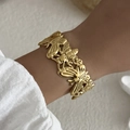 Gold stainless steel cuff bracelet featuring embossed butterfly and bee insect designs - Butterfly Bee Relief (BR25Y0787)