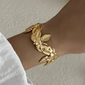 Elegant gold leaf bangle in a wrap design with detailed veins for women's beach vacation style - Overlapping Leaves (BR25Y0790)