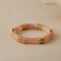 Close-up of pink bamboo-shaped resin bracelet segments with ribbed gold metal rings - Pink Marble (AB0070-2)